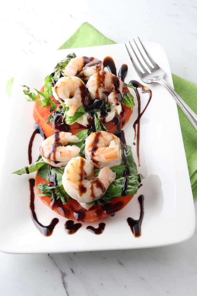 caprice salad with shrimp and balsamic glaze